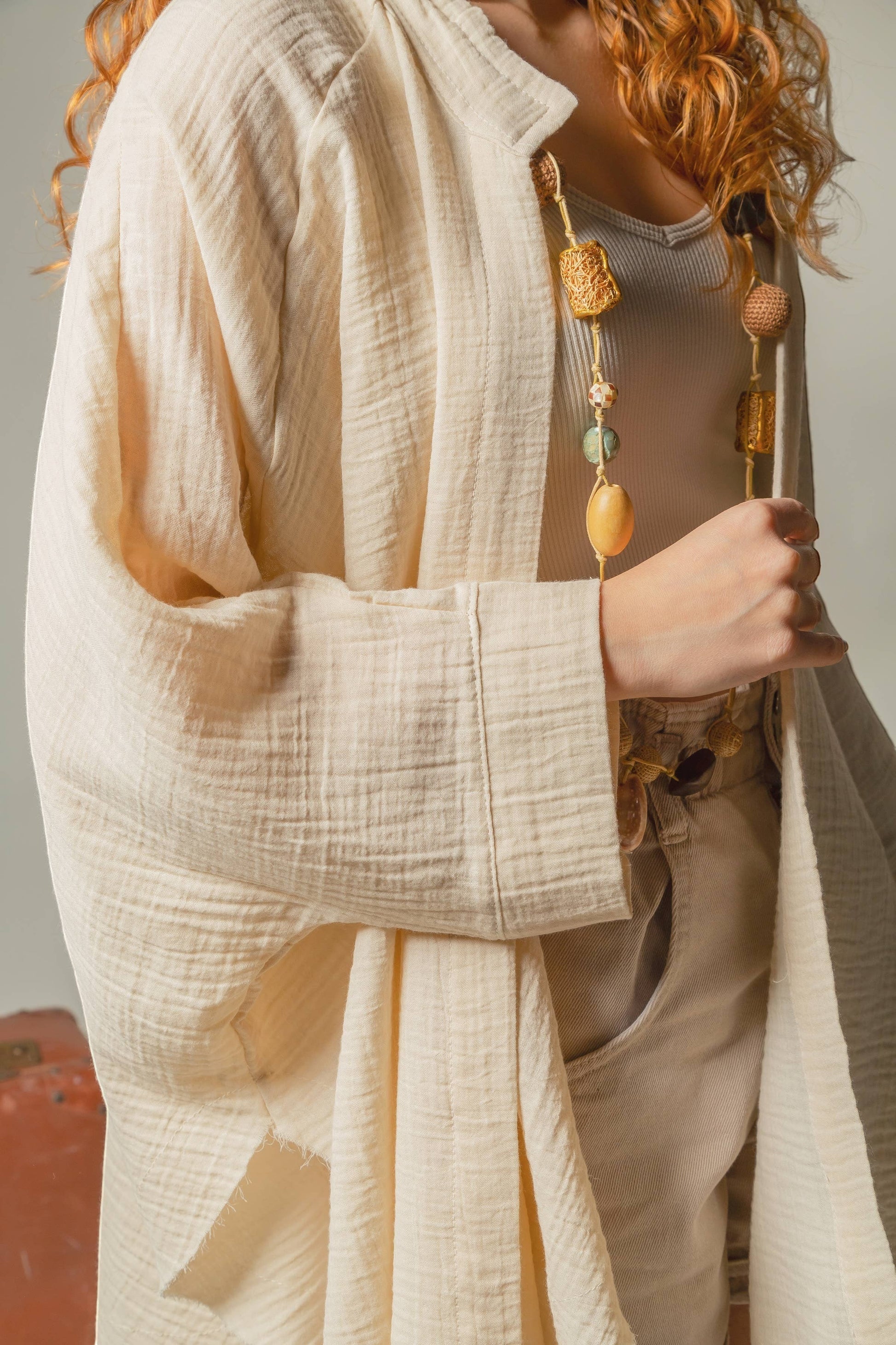 Mellow Monkey cream 4-layer muslin kimono robe with hand-painted evil eye detail on back. Organic cotton.