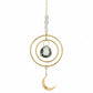 Mellow Monkey celestial crescent moon suncatcher with gold rings, metallic chains, and a clear crystal prism.