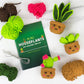 Mellow Monkey Pocket Crochet Mini Houseplants DIY kit with yarn, crochet hooks, instruction booklet, and three finished plush succulents.