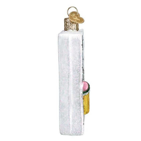 Mellow Monkey white blown glass crossword puzzle ornament with pink pencil and green eraser detail.