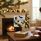 Mellow Monkey Crossword Puzzle blown glass holiday ornament with "Merry Christmas" and a gold pencil.