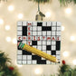Mellow Monkey Crossword Puzzle blown glass holiday ornament with glitter pencil and "Merry Christmas" text.