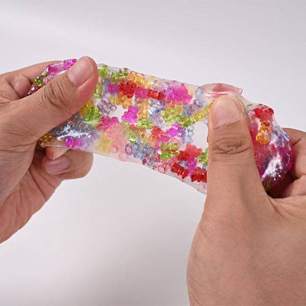Mellow Monkey Crunch & Squish candy-themed sensory fidget toy being stretched to show colorful crunchy beads inside