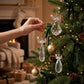 Mellow Monkey crystal angel ornaments with gold halos hanging on a decorated Christmas tree