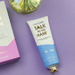 Mellow Monkey Talk to the Hand cypress and juniper scented hand cream in a white and blue tube with a gold cap.