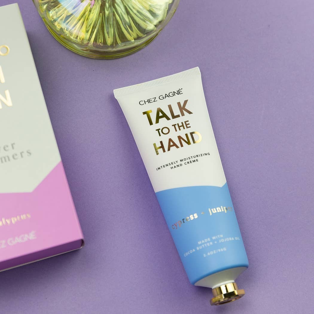 Mellow Monkey Talk to the Hand cypress and juniper scented hand cream in a white and blue tube with a gold cap.