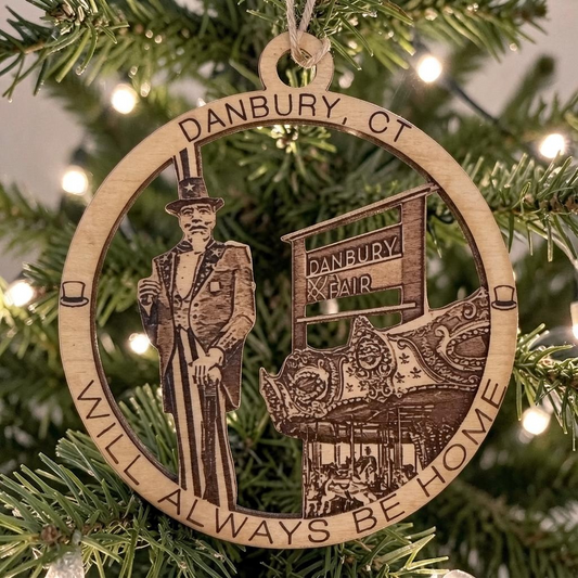 Mellow Monkey 4-inch round wooden ornament featuring Danbury Fair imagery and text hanging on a Christmas tree