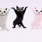 Mellow Monkey 2-inch dancing cat figurines in grey tabby, black, and pink standing in a row on a white background.