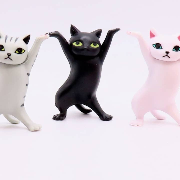 Mellow Monkey 2-inch dancing cat figurines in grey tabby, black, and pink standing in a row on a white background.