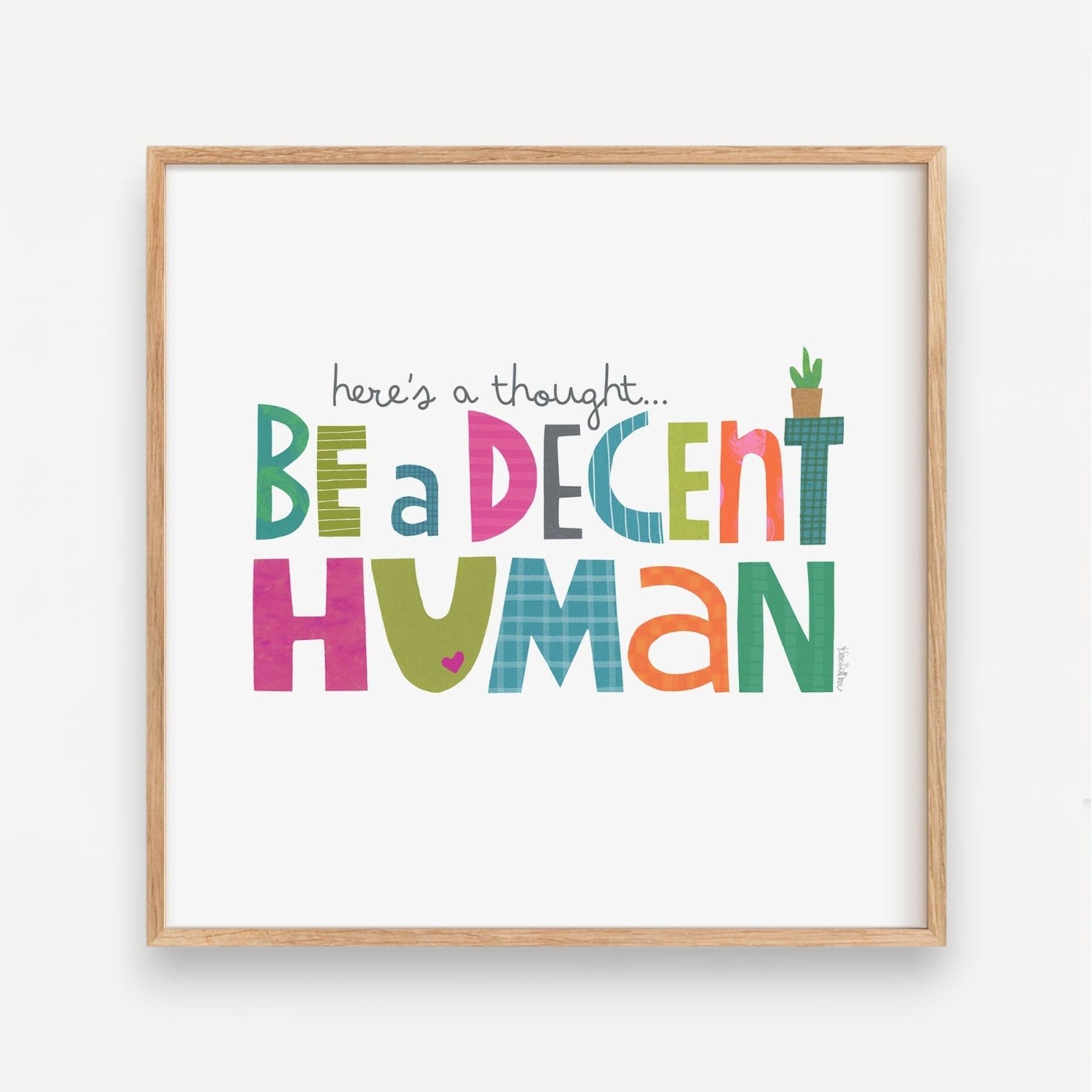 Mellow Monkey framed art print with colorful text reading "here's a thought... BE a DECENT HUMAN" and a small potted plant.