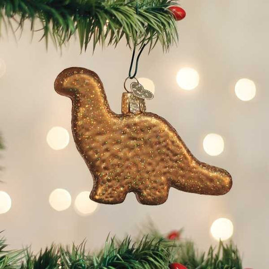 Mellow Monkey bronze glitter dinosaur ornament hanging on a Christmas tree.