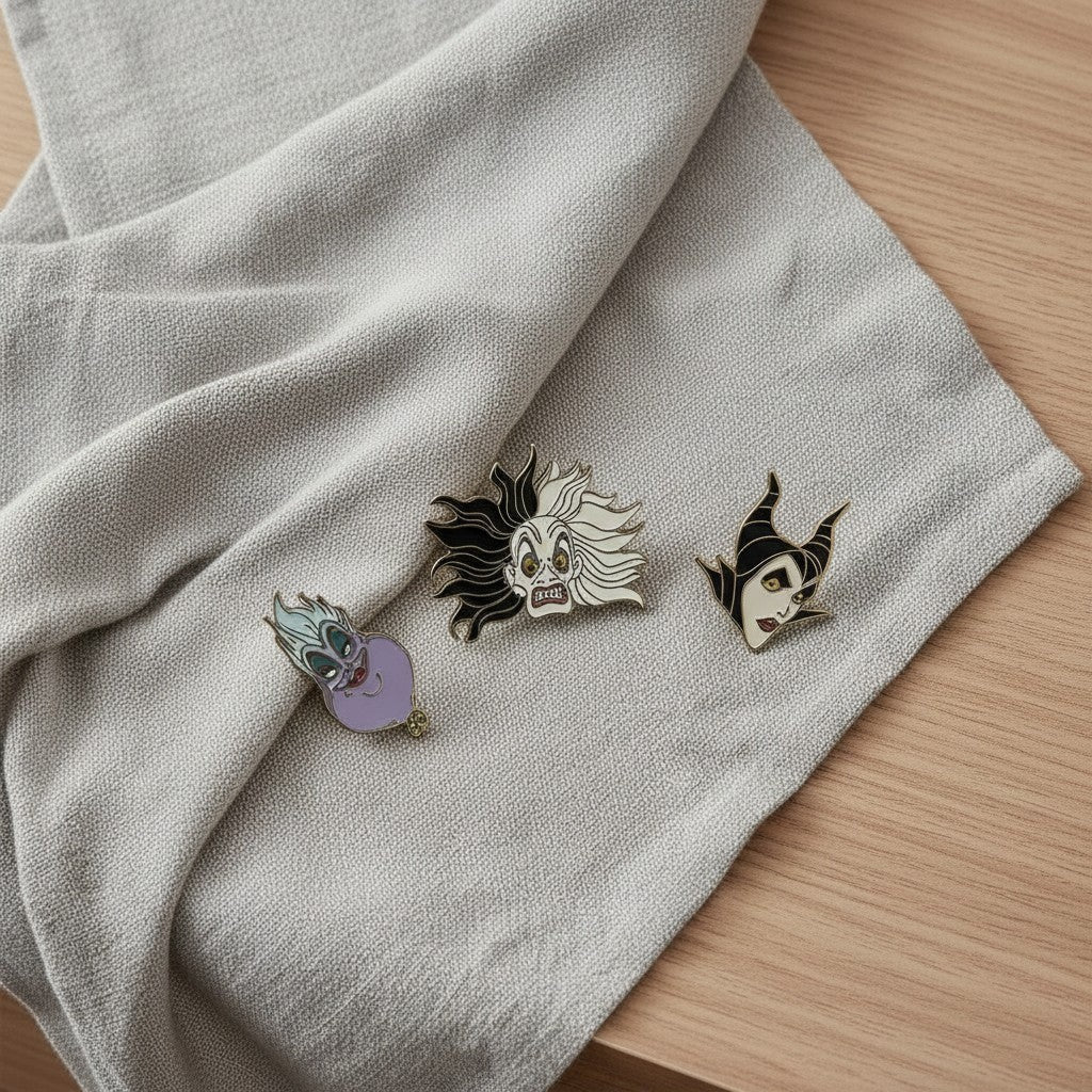 Mellow Monkey Disney Villains enamel pin set featuring Ursula, Cruella De Vil, and Maleficent on a grey cloth