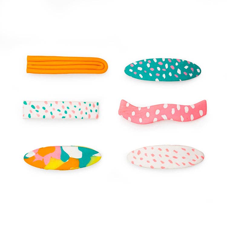 Mellow Monkey DIY hair clip kit featuring six colorful handmade polymer clay hair accessories in various patterns.