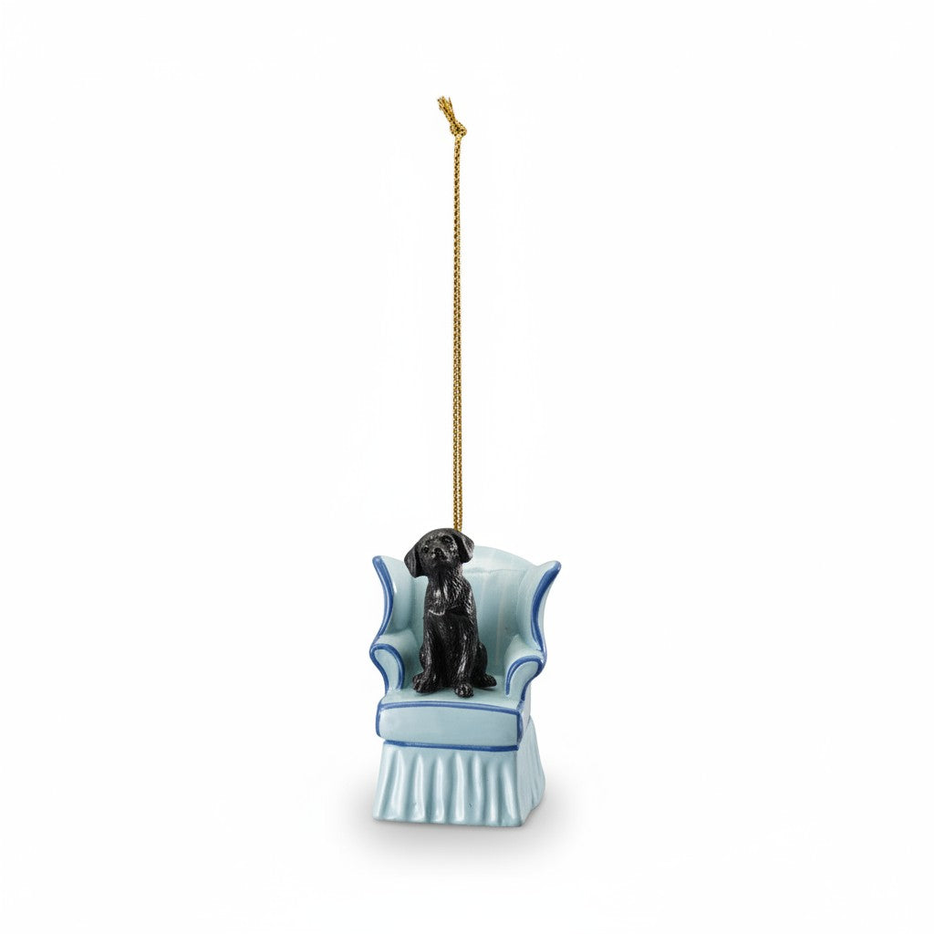 Mellow Monkey resin ornament featuring a black dog sitting in a light blue vintage wingback chair with gold cord