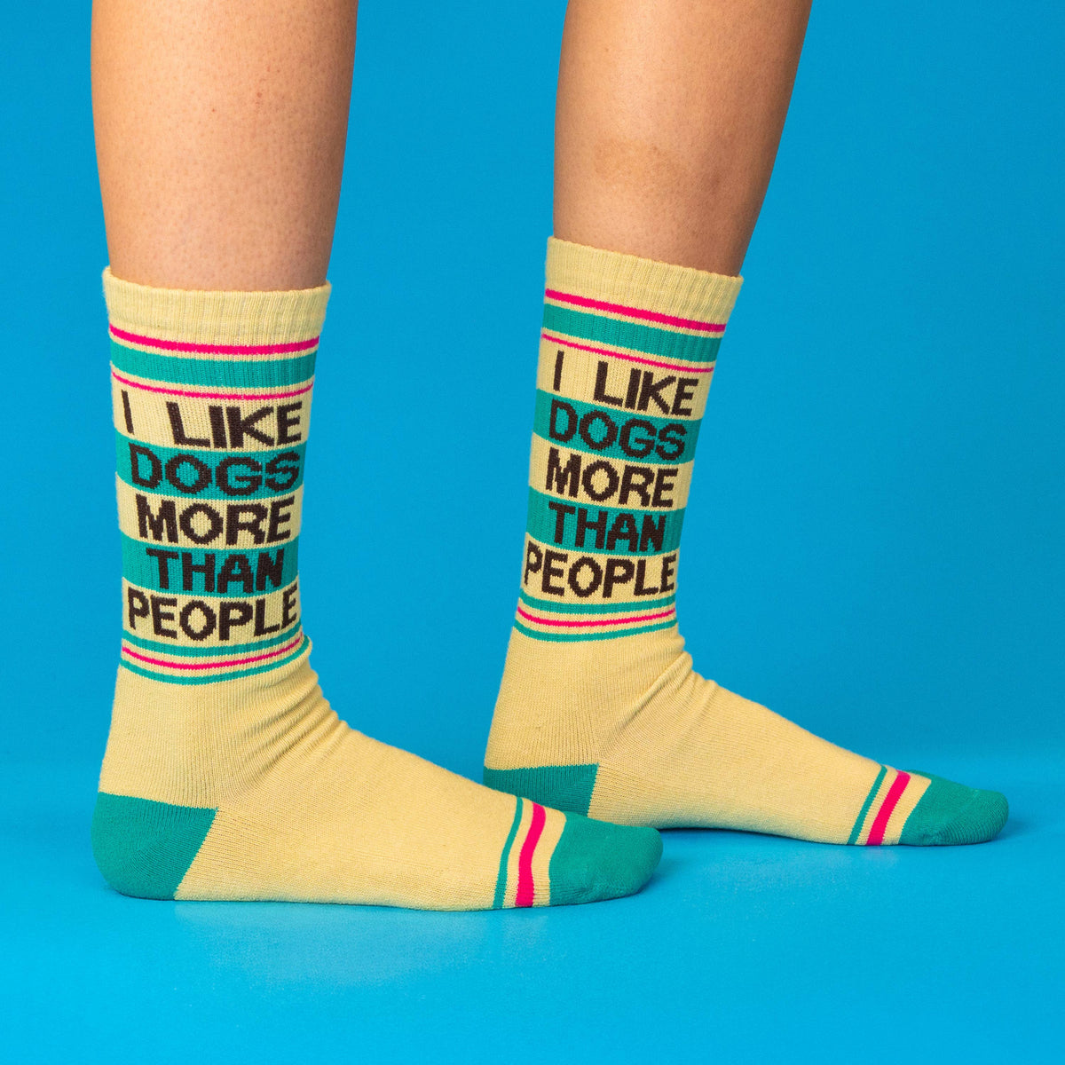 Mellow Monkey gym crew socks in yellow with teal and pink stripes and the text I Like Dogs More Than People