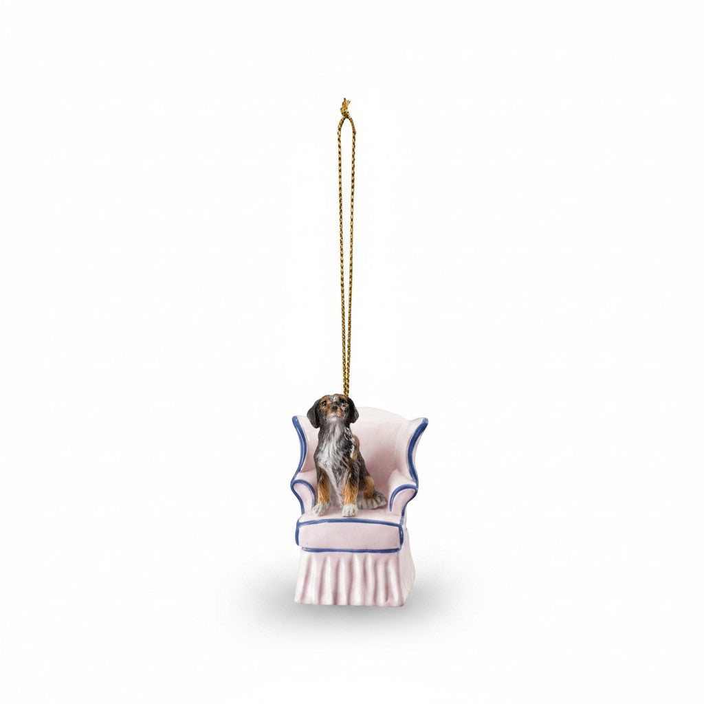 Mellow Monkey resin dog ornament featuring a small dog sitting in a pink and blue vintage wingback chair