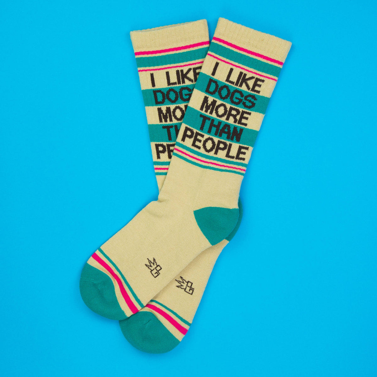 Mellow Monkey crew socks in beige with teal accents and the text I Like Dogs More Than People on a blue background.