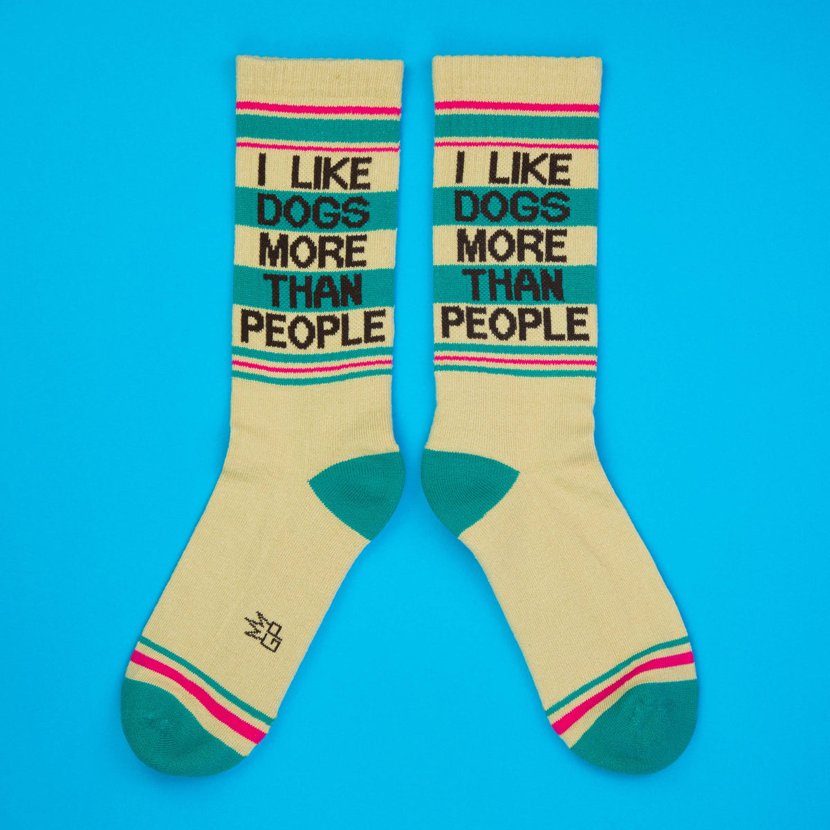 Mellow Monkey crew socks in beige with teal and pink stripes, featuring the text I Like Dogs More Than People.