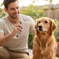 Mellow Monkey Really Good Doggie Deodorizer spray being applied to a golden retriever by a smiling man outdoors