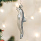 Mellow Monkey Playful Dolphin Old World Christmas blown glass ornament, 5-inch, silver with glitter accents, hanging on a tree.