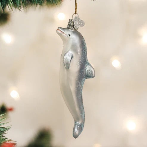 Mellow Monkey Playful Dolphin Old World Christmas blown glass ornament, 5-inch, silver with glitter accents, hanging on a tree.