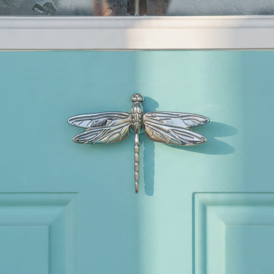 Mellow Monkey nickel silver dragonfly door knocker mounted on a light blue front door
