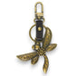Mellow Monkey antique bronze dragonfly keychain with faux leather strap and metal hardware. Attaches to keys or bags.