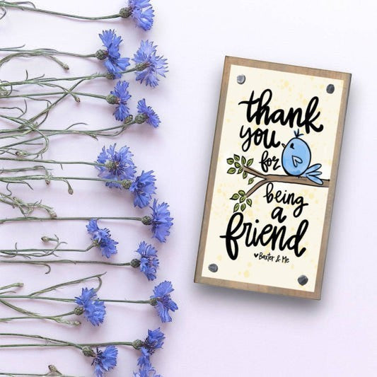 Mellow Monkey Thank You For Being A Friend driftwood block sign with a blue bird illustration on a light background.