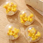 Mellow Monkey clear air-filled stress balls containing small yellow rubber ducks on a wooden surface