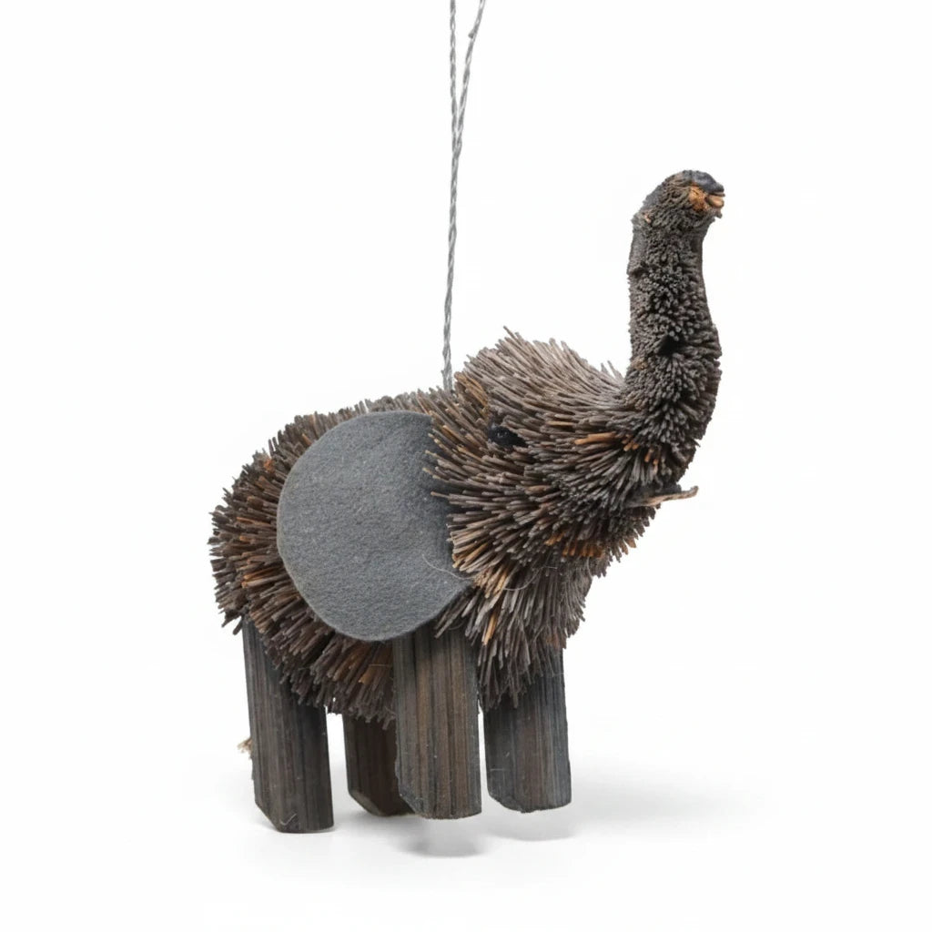Mellow Monkey elephant holiday ornament made from natural bottle brush fibers with a grey felt ear on white background