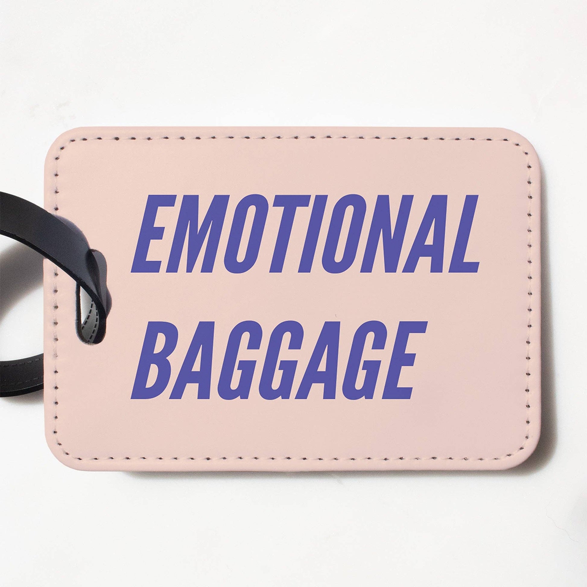 Mellow Monkey pink faux leather luggage tag with Emotional Baggage text in purple font and a black strap