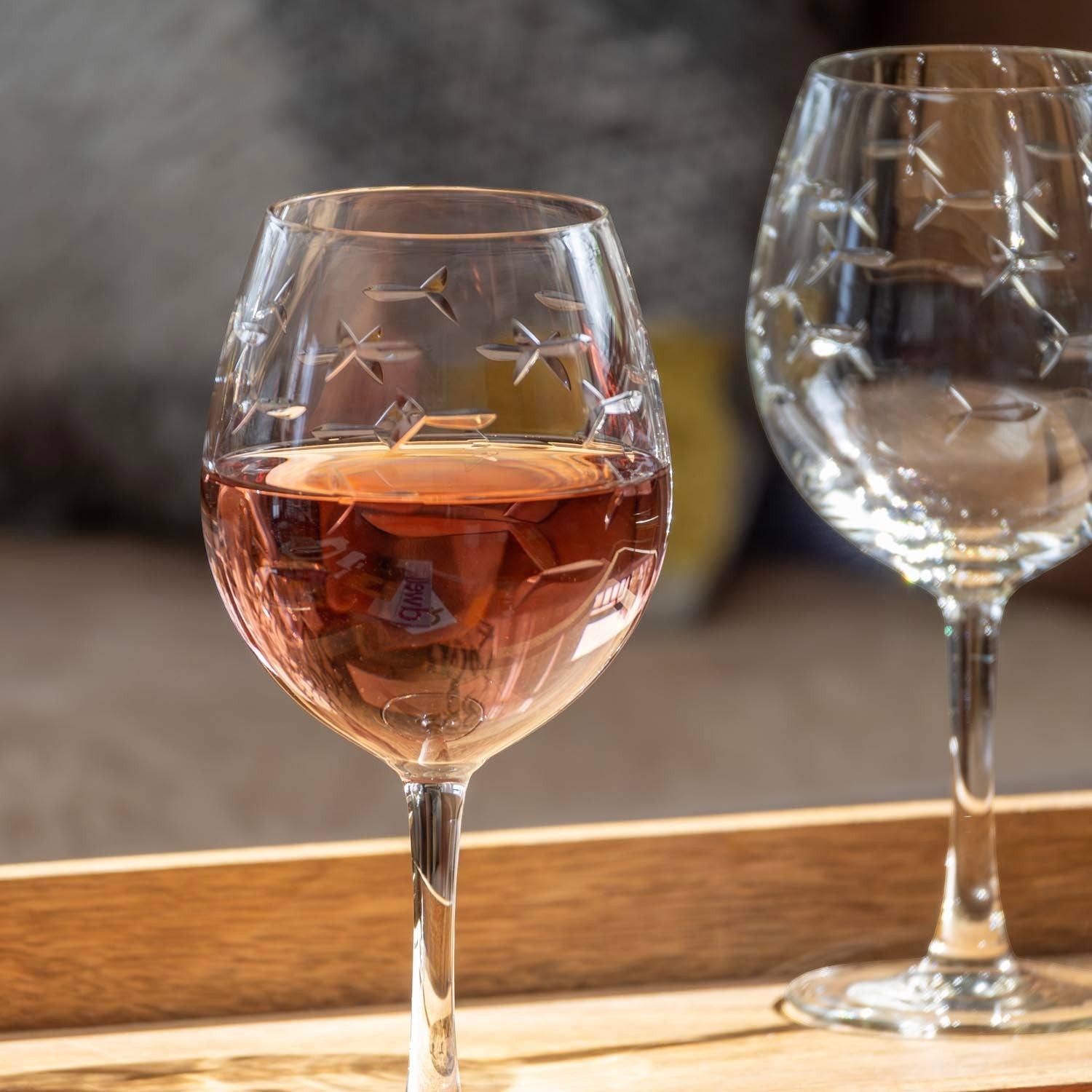 Mellow Monkey 18-oz balloon red wine glass featuring an etched school of fish design on clear domestic glass