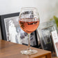 Mellow Monkey 18-oz balloon red wine glass featuring an etched school of fish design filled with rose wine.