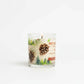 Mellow Monkey Pet House candle in Evergreen Forest scent with pine cone and forest illustrations on a glass jar