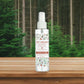 Mellow Monkey Evergreen Forest pet odor neutralizing room spray in a 4-ounce clear bottle against a forest background.