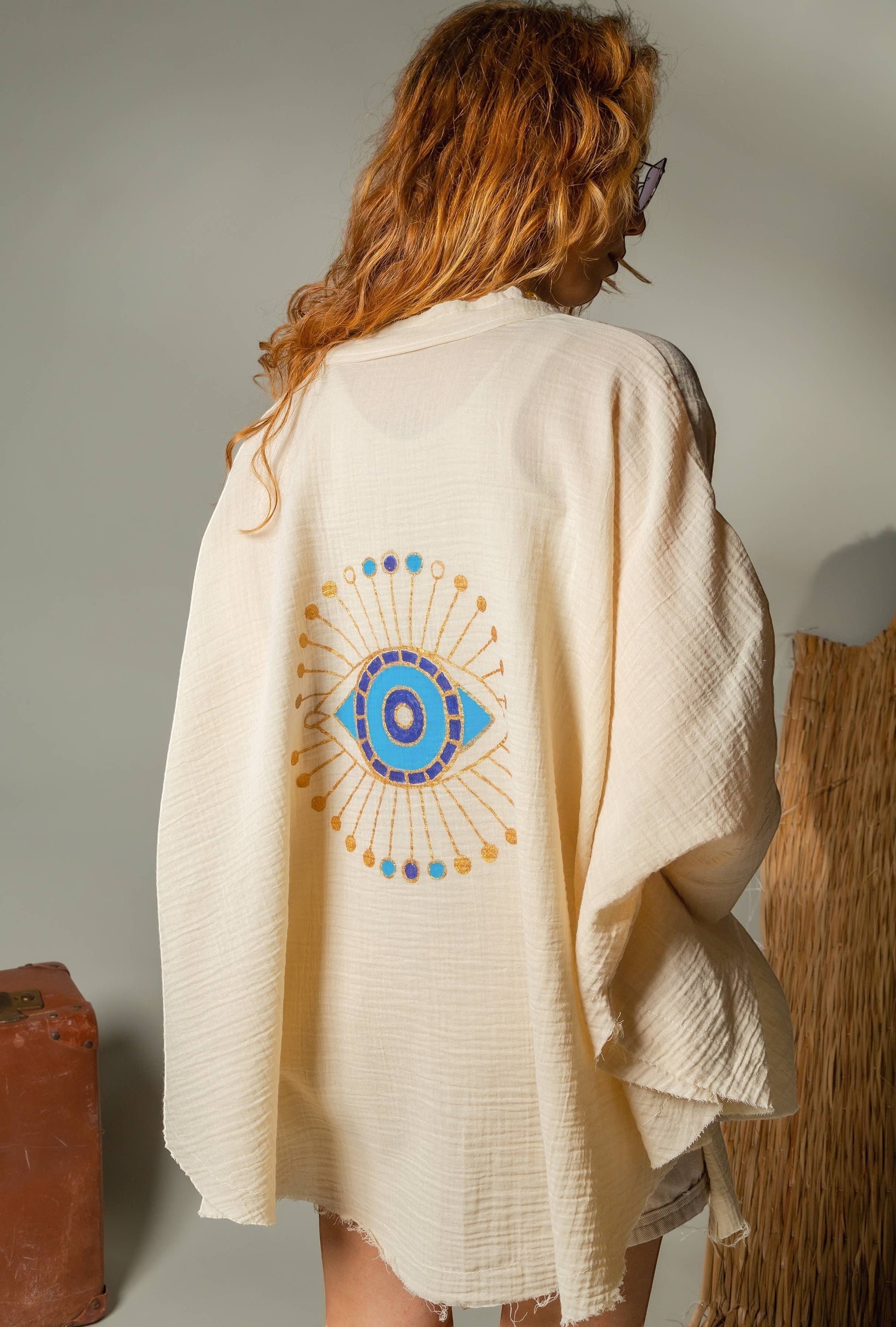 Mellow Monkey cream 4-layer muslin kimono robe with hand-painted blue and gold evil eye on back. One size.