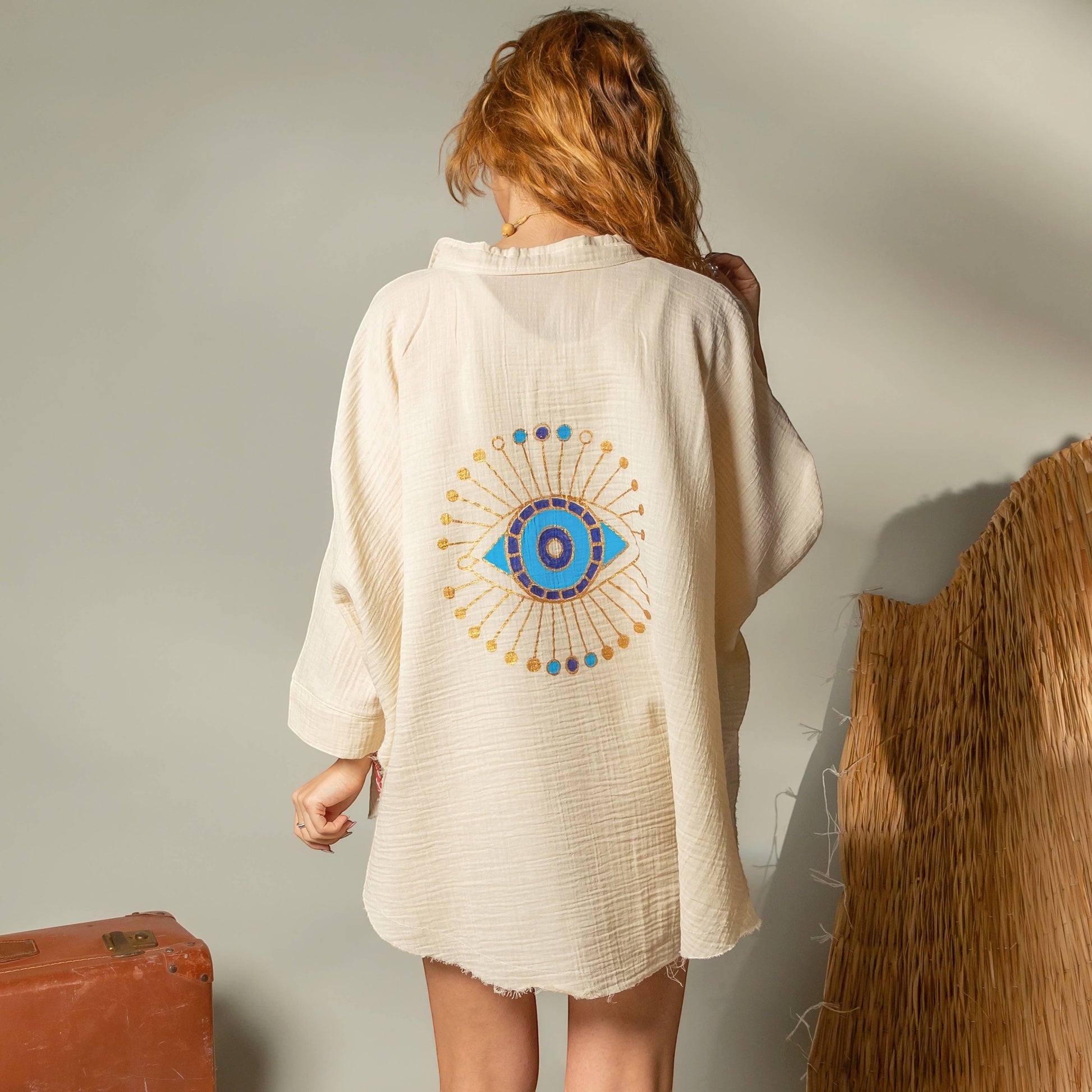 Mellow Monkey cream 4-layer muslin kimono robe with hand-painted blue and gold evil eye design on back. One size.