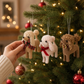 Mellow Monkey fabric poodle ornaments with bows hanging on a Christmas tree, featuring curly fur and festive ribbons.