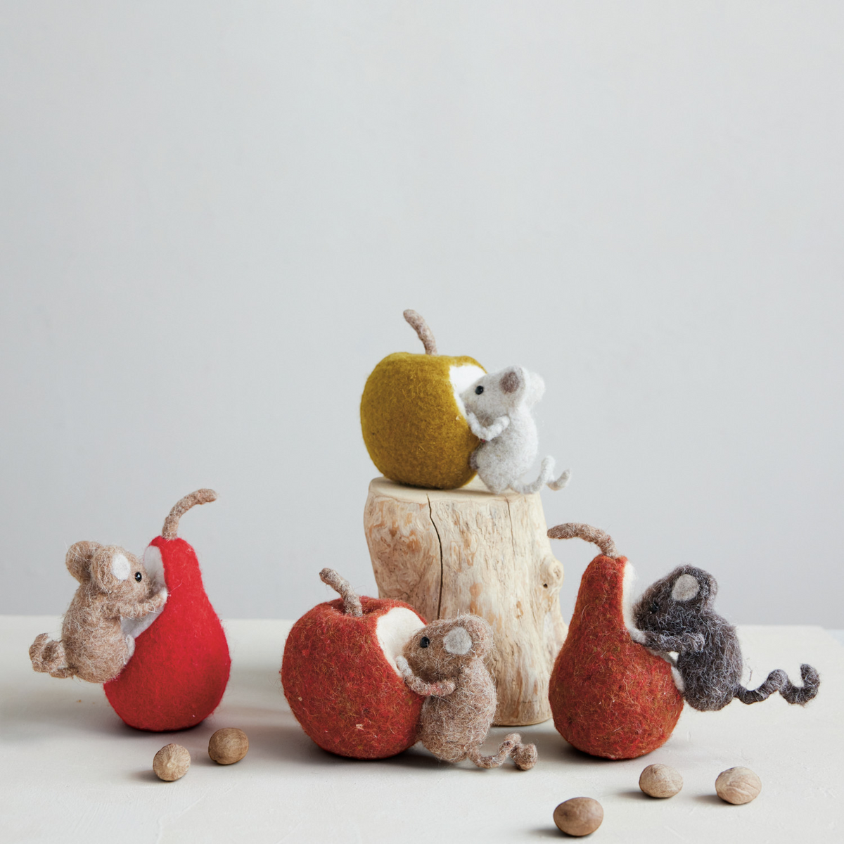 Mellow Monkey handmade felted wool mouse figurines interacting with various felt fruits on a wooden display stand.