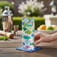 Mellow Monkey Make A Splash 10oz glass tumbler with colorful fish decals on a wooden table with cocktail tools
