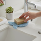 Mellow Monkey Fish Soap Lift in seaside blue, a bioplastic draining pad for bar soap on a bathroom vanity.