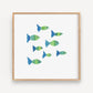 Mellow Monkey Fishies Framed Art Print, a school of green and blue fish swimming together in a wooden frame.