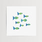 Mellow Monkey Fishies Framed Art Print, featuring a school of green and blue fish with original watercolor-style designs.