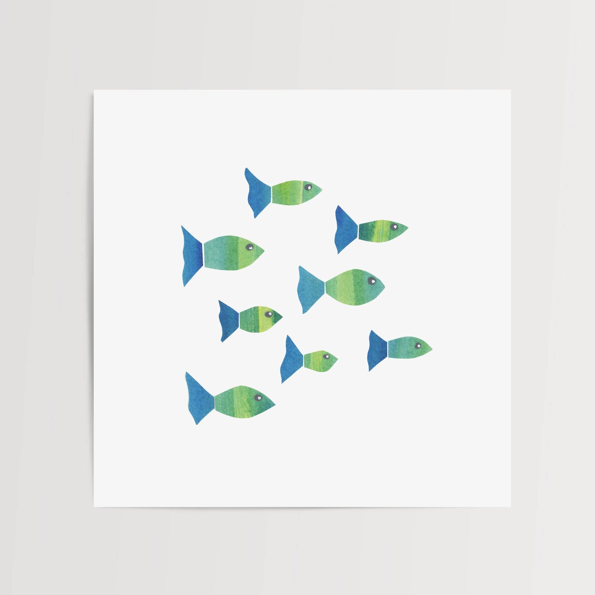 Mellow Monkey Fishies Framed Art Print, featuring a school of green and blue fish with original watercolor-style designs.