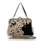 Mellow Monkey floral kisslock bag featuring a black velvet cat and butterfly appliqué with vintage metal hardware.