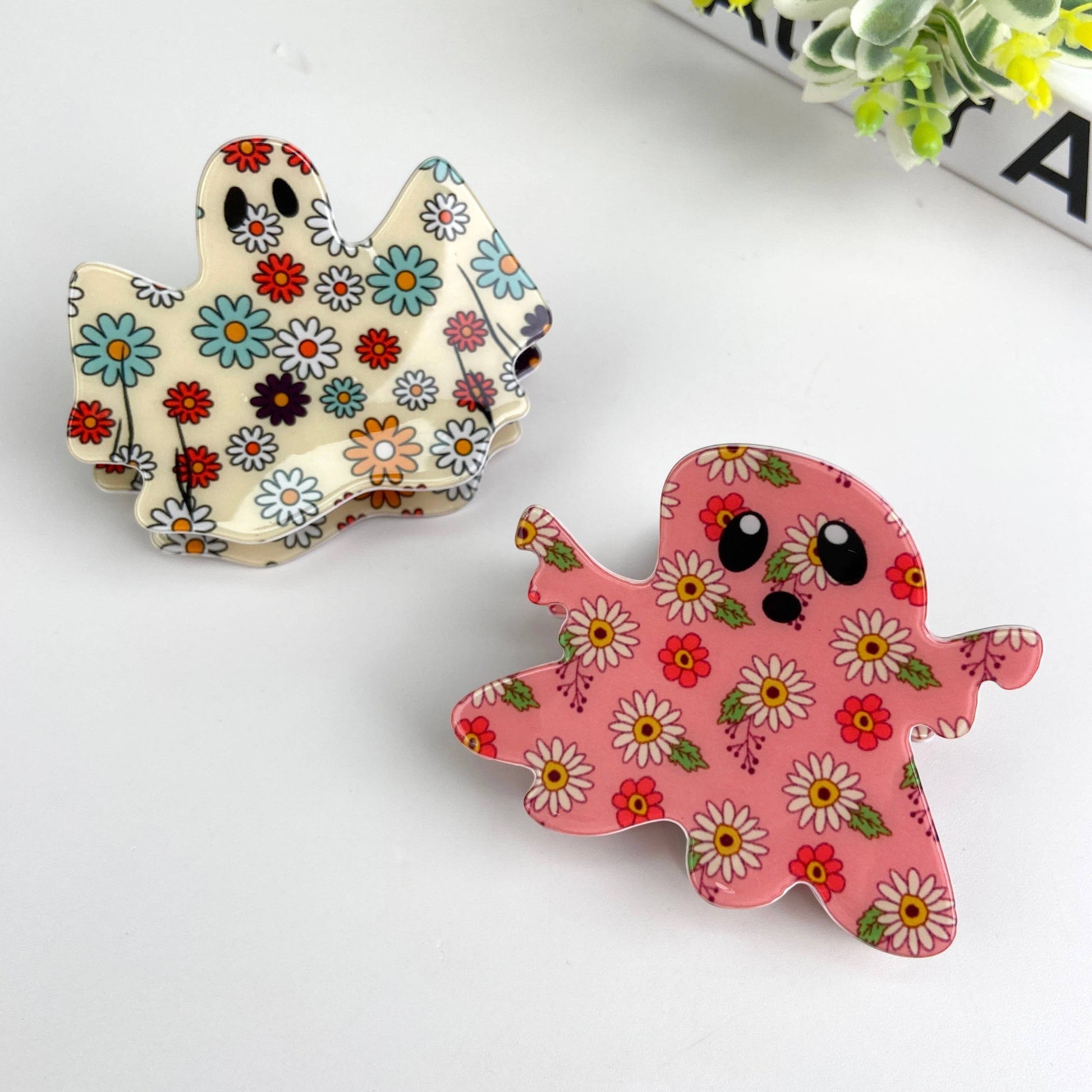 Mellow Monkey handmade PVC ghost hair claw clips featuring cute floral patterns in cream and pink pastel colors.