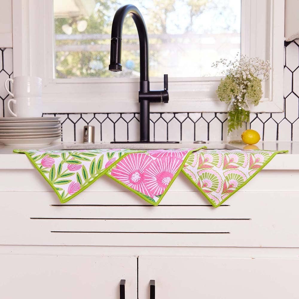 Mellow Monkey floral kitchen dish towel set with pink flowers and green foliage on white fabric with lime green trim.