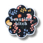 Mellow Monkey 3-inch flower-shaped waterproof vinyl sticker with a black floral pattern and white Beautiful Bitch text.