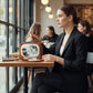 Woman in a cafe with a Mellow Monkey Frankenstein and Bride vintage TV shaped vinyl crossbody bag.