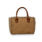 Mellow Monkey Sel De Mer canvas and leather handbag with frayed edges and caramel brown handles on a white background.